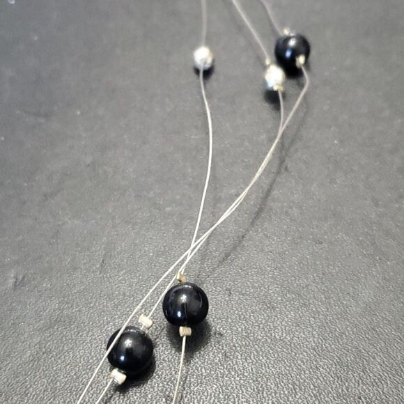 Silver tone black flower floating necklace - Picture 4 of 11